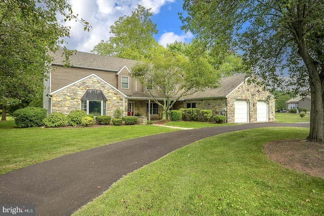 view of front of home featuring a garage and a front lawn