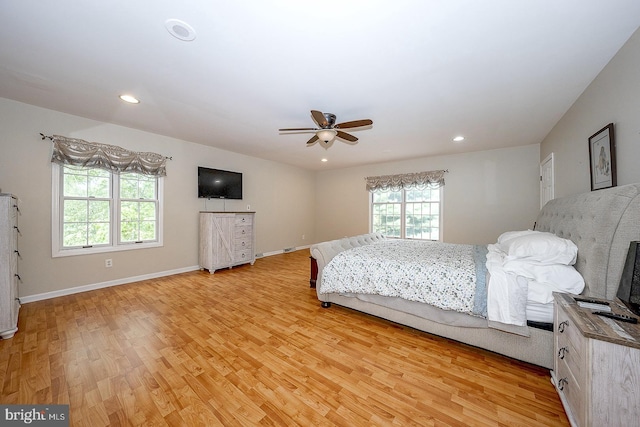 bedroom with light hardwood / wood-style flooring and ceiling fan