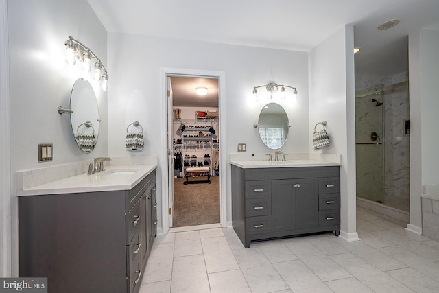 bathroom featuring vanity, a shower with shower door, and tile patterned floors