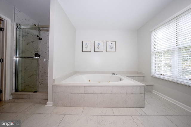 bathroom featuring a wealth of natural light and plus walk in shower