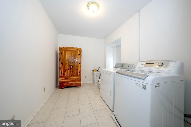 clothes washing area with separate washer and dryer