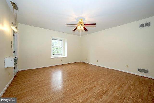 empty room featuring light hardwood / wood-style flooring and ceiling fan