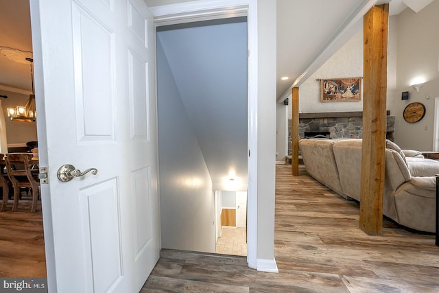 hallway with a chandelier and wood-type flooring