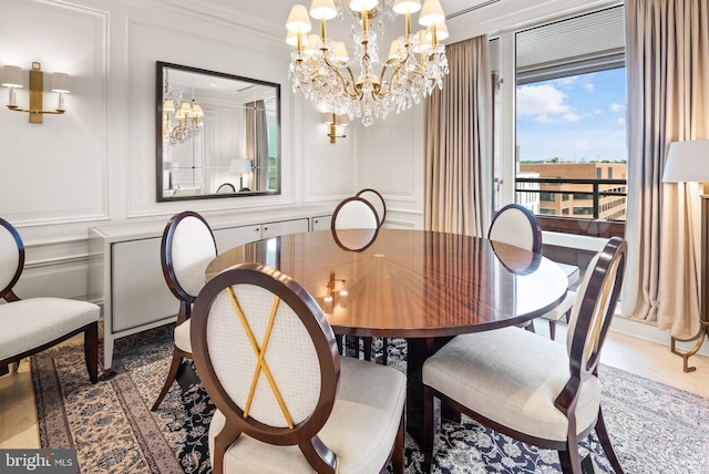 dining area featuring a chandelier, wood-type flooring, and crown molding