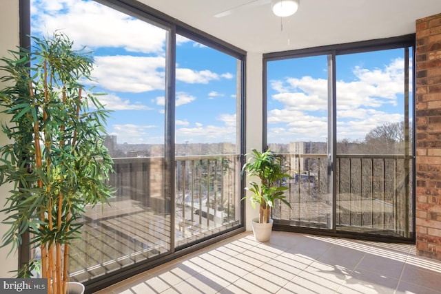 unfurnished sunroom featuring ceiling fan