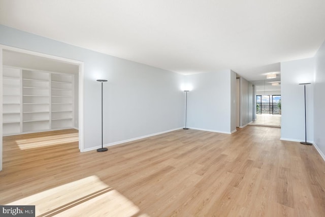 unfurnished room with light wood-type flooring