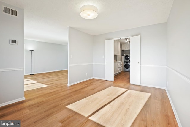 spare room featuring washer / clothes dryer and wood-type flooring