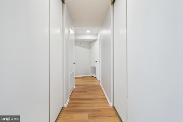 hall with light hardwood / wood-style flooring