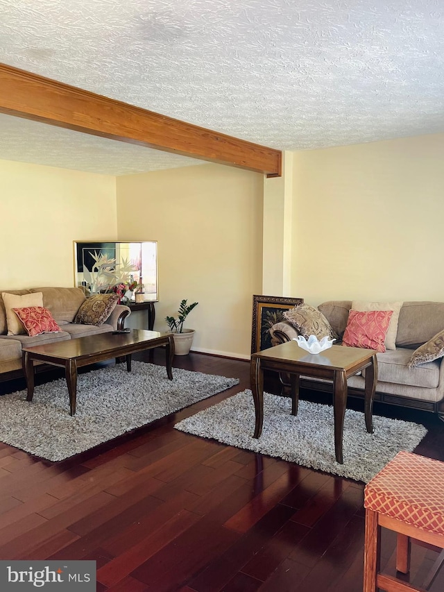 living room featuring wood-type flooring and a textured ceiling