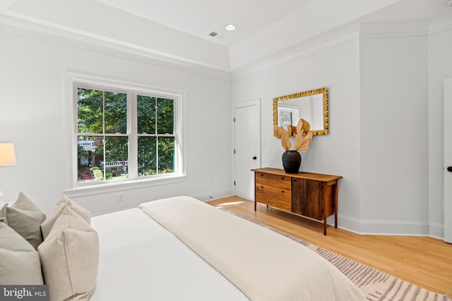 bedroom featuring multiple windows and light hardwood / wood-style flooring