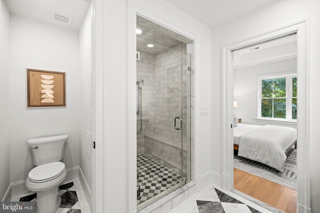 bathroom featuring toilet, wood-type flooring, and walk in shower