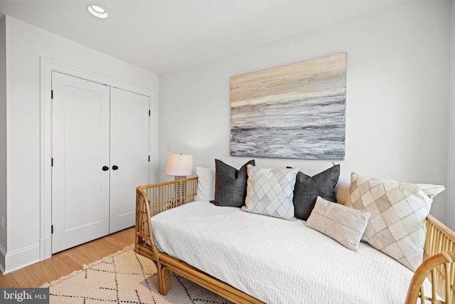 bedroom with a closet and light hardwood / wood-style flooring