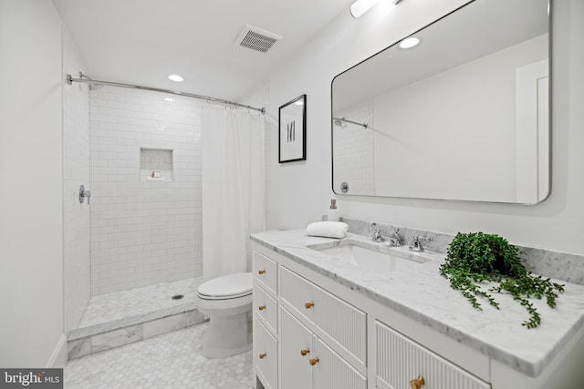 bathroom featuring vanity, toilet, curtained shower, and tile patterned flooring