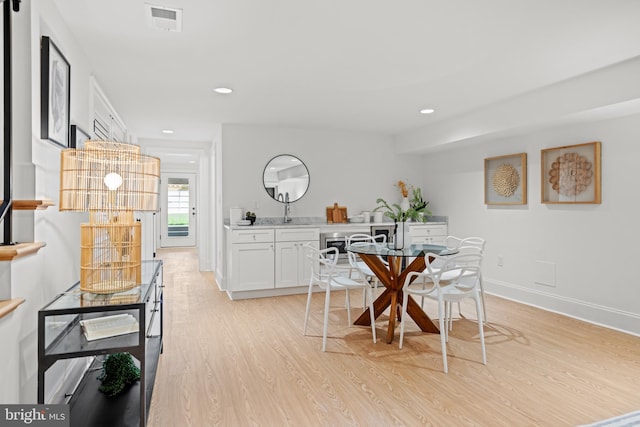 dining room with light hardwood / wood-style flooring