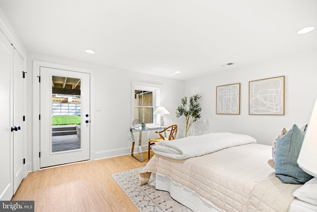 bedroom featuring access to exterior and light hardwood / wood-style floors