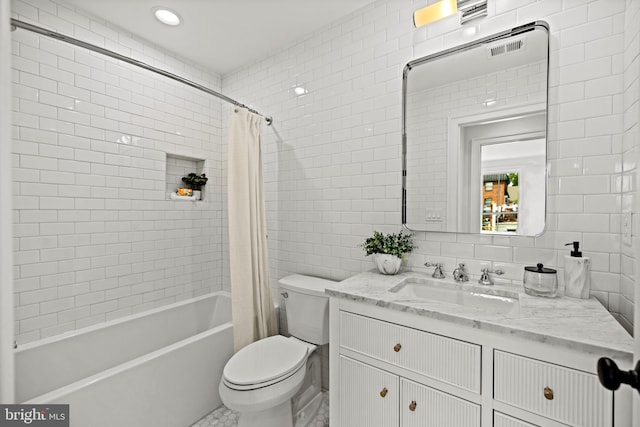 full bathroom with vanity, toilet, tile walls, and shower / bathtub combination with curtain