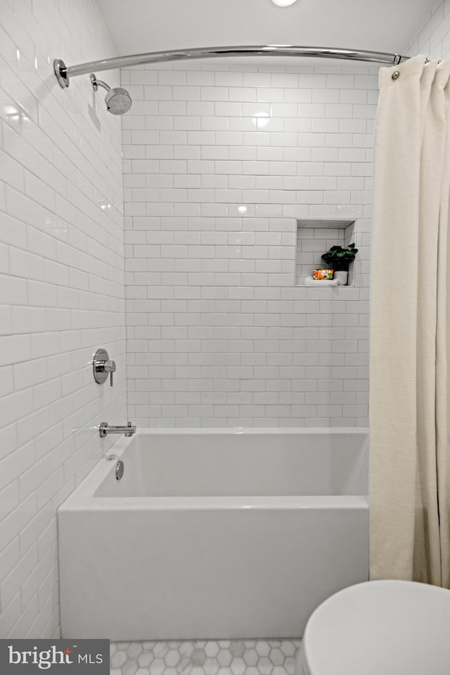 bathroom with shower / bath combo with shower curtain and toilet