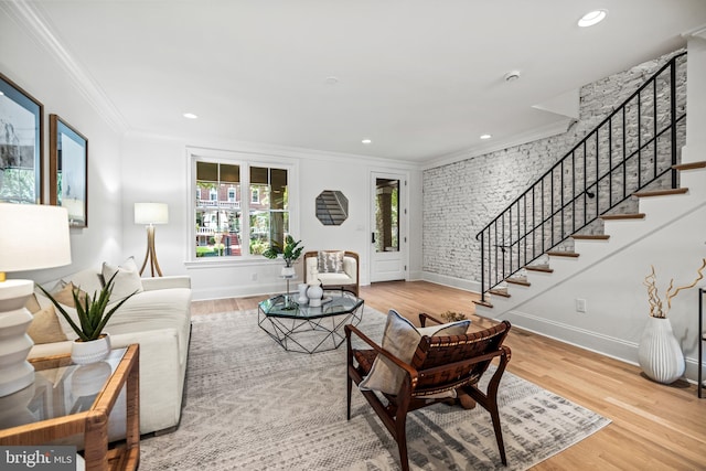 living room featuring ornamental molding and light hardwood / wood-style flooring