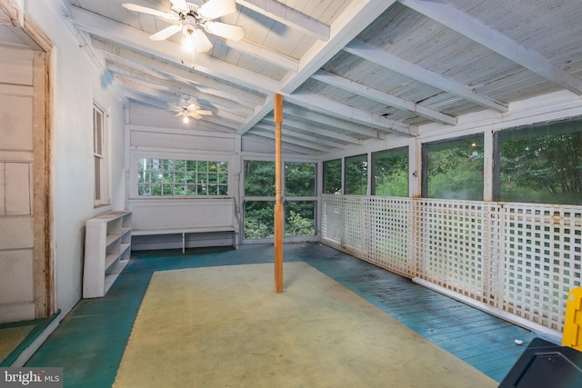 unfurnished sunroom featuring vaulted ceiling with beams and ceiling fan