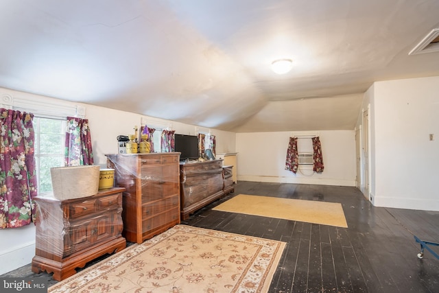 bedroom with dark wood-type flooring and vaulted ceiling