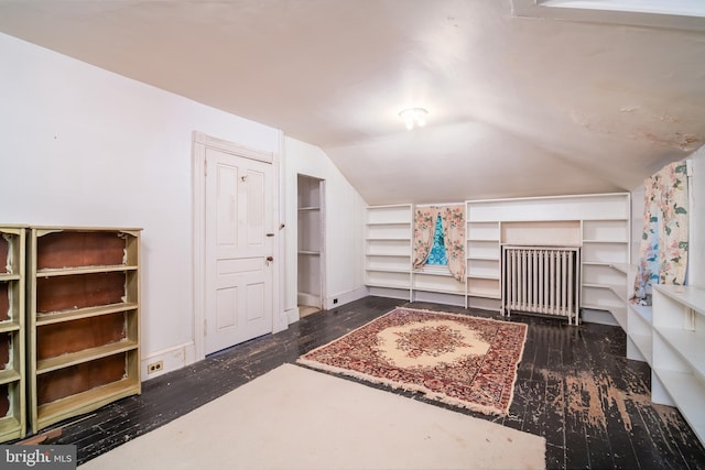 bonus room with vaulted ceiling and dark hardwood / wood-style flooring