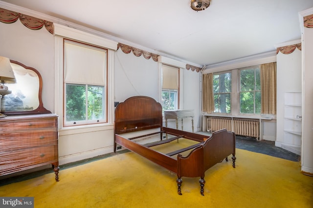 bedroom featuring ornamental molding, radiator heating unit, and carpet floors