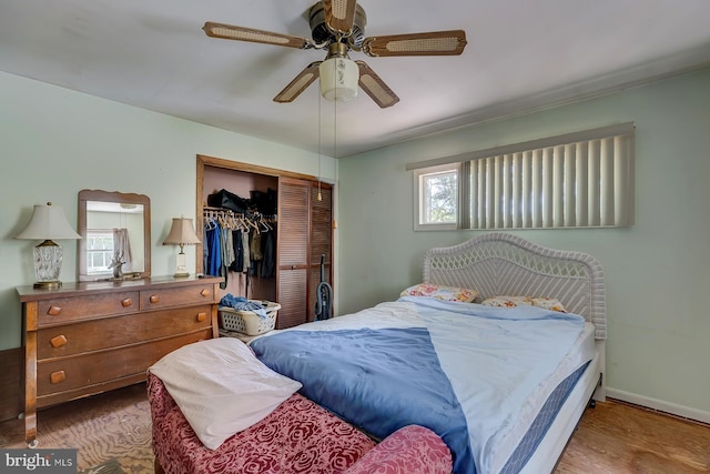 bedroom with ceiling fan, a closet, and wood-type flooring