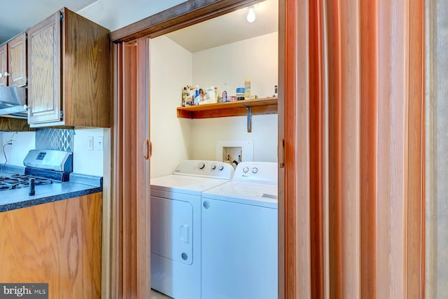 clothes washing area featuring independent washer and dryer