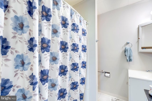 bathroom featuring crown molding, vanity, tile patterned floors, and walk in shower