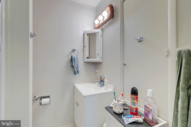 bathroom with crown molding and vanity