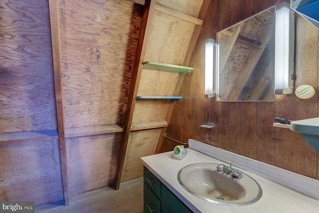 bathroom featuring wood walls and vanity