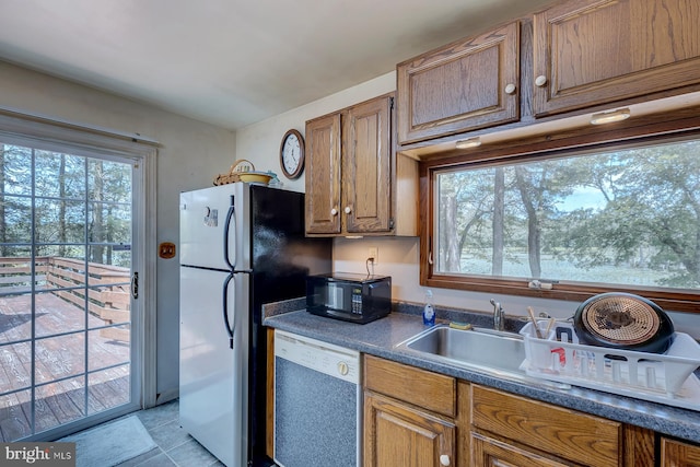 kitchen featuring stainless steel appliances and light tile patterned flooring