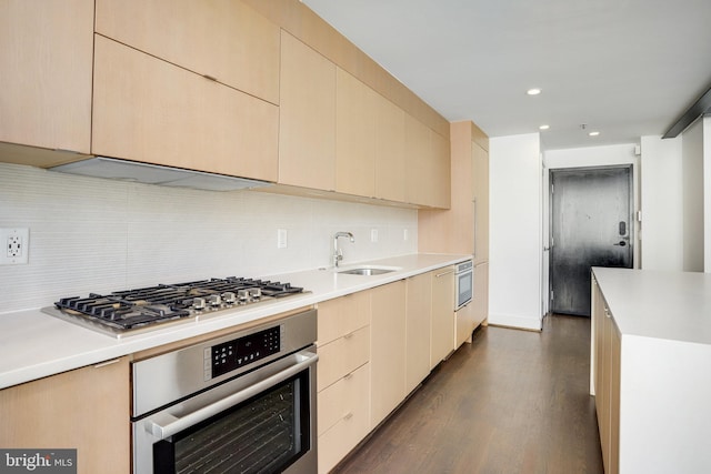 kitchen with light brown cabinetry, sink, appliances with stainless steel finishes, and dark hardwood / wood-style flooring