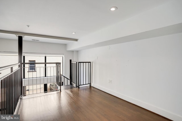 unfurnished room with dark wood-type flooring