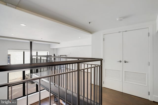 corridor with dark hardwood / wood-style flooring