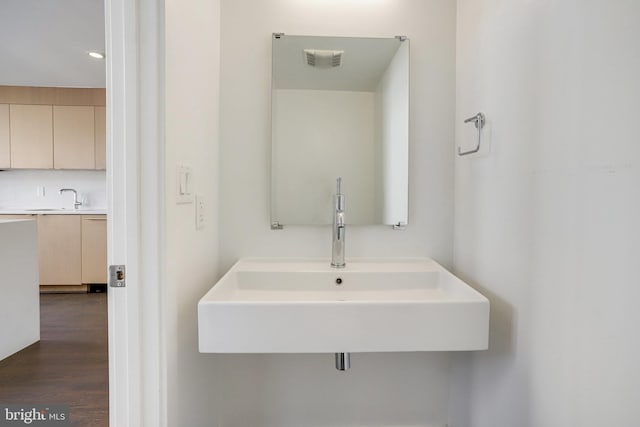 bathroom with hardwood / wood-style floors and sink