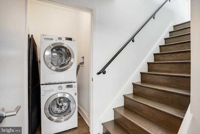 washroom featuring stacked washer / drying machine