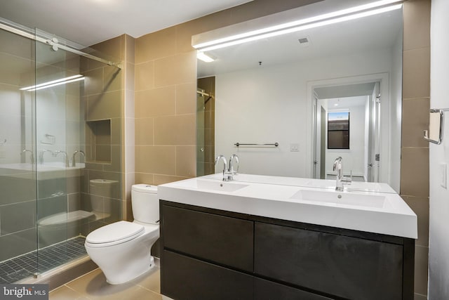 bathroom with vanity, toilet, tile patterned floors, and walk in shower