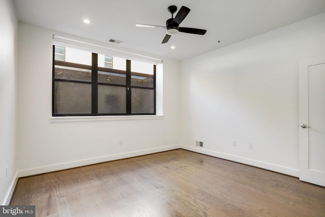 spare room featuring hardwood / wood-style flooring and ceiling fan