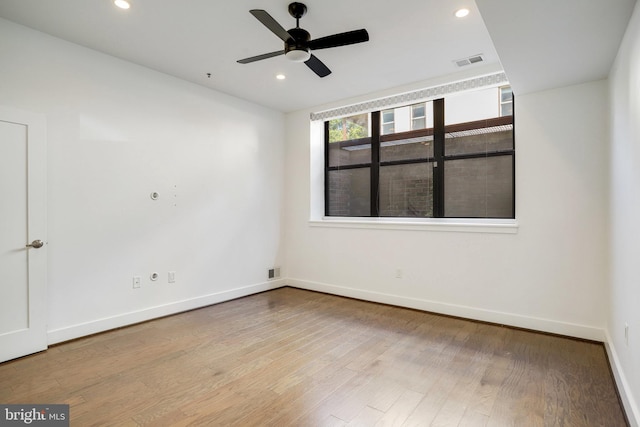 empty room featuring ceiling fan and light hardwood / wood-style floors