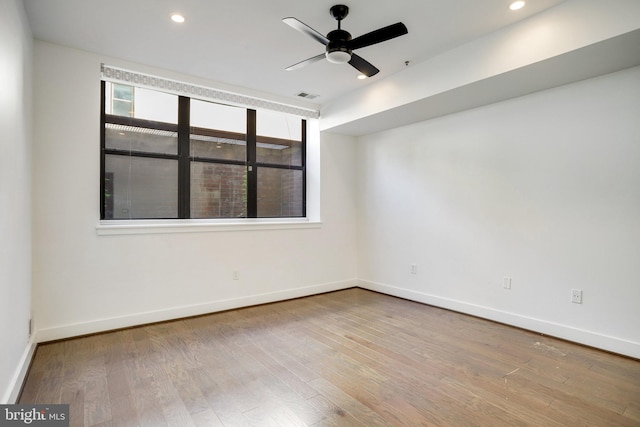 spare room with hardwood / wood-style floors and ceiling fan