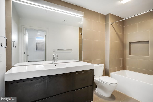 full bathroom with tiled shower / bath combo, vanity, toilet, and tile patterned flooring