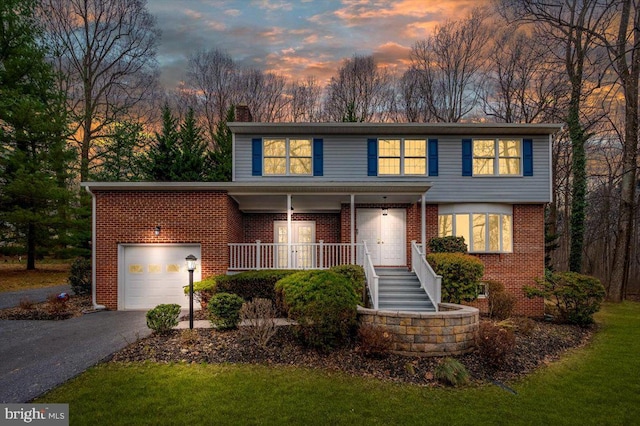 front of property featuring a porch and a garage