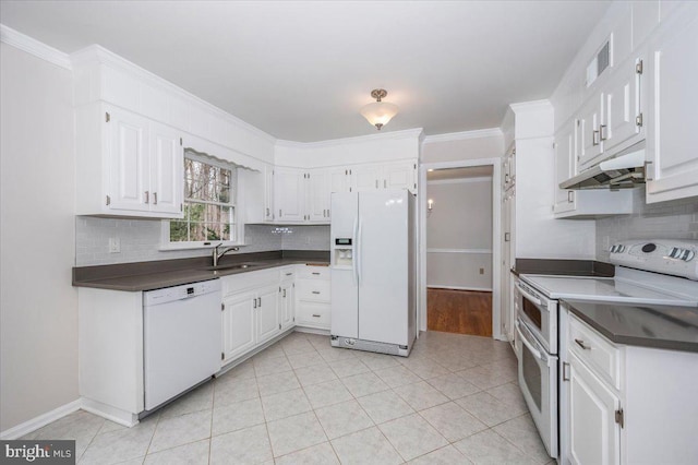 kitchen with white cabinetry, sink, white appliances, light tile patterned flooring, and ornamental molding