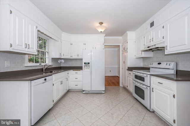 kitchen with sink, light tile patterned floors, white appliances, white cabinets, and ornamental molding