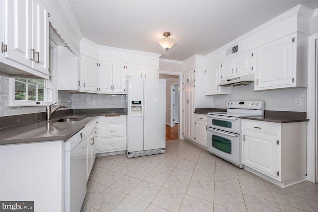 kitchen with light tile patterned floors, white appliances, white cabinetry, and sink