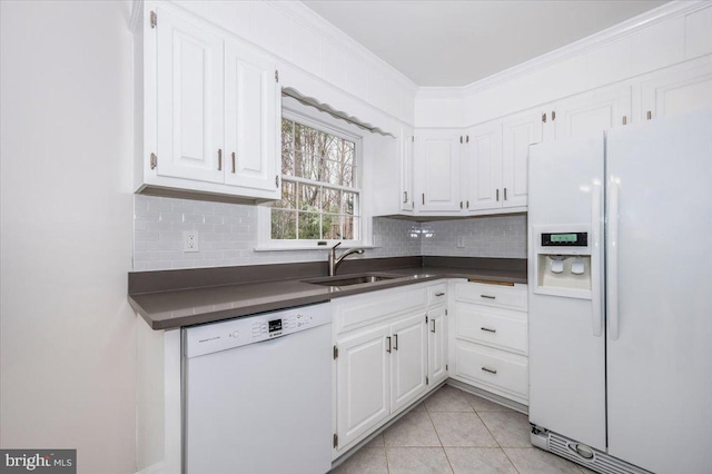 kitchen with white cabinetry, sink, light tile patterned floors, and white appliances