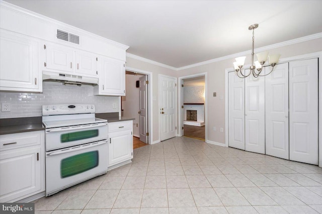 kitchen with hanging light fixtures, white electric stove, crown molding, a chandelier, and white cabinets