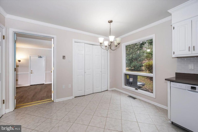 unfurnished dining area featuring light tile patterned floors, a chandelier, and ornamental molding