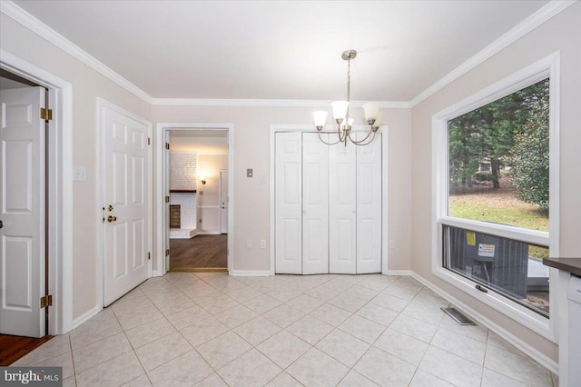 unfurnished dining area with light tile patterned floors, crown molding, and an inviting chandelier